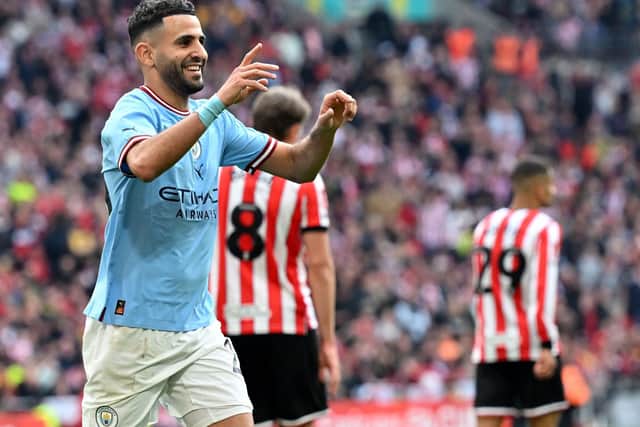 Manchester City's Algerian midfielder Riyad Mahrez celebrates scoring the team's third goal, his hat trick, during the English FA Cup semi-final football match between Manchester City and Sheffield United: GLYN KIRK/AFP via Getty Images