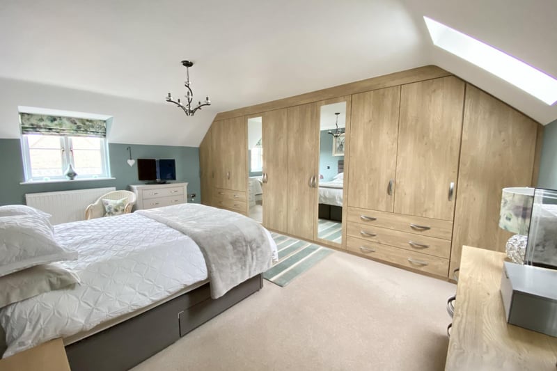 Fitted with an extensive range of double and single wardrobes with a mixture of shelving, overhead storage space, hanging rails and two inset vanity mirror door fronts.