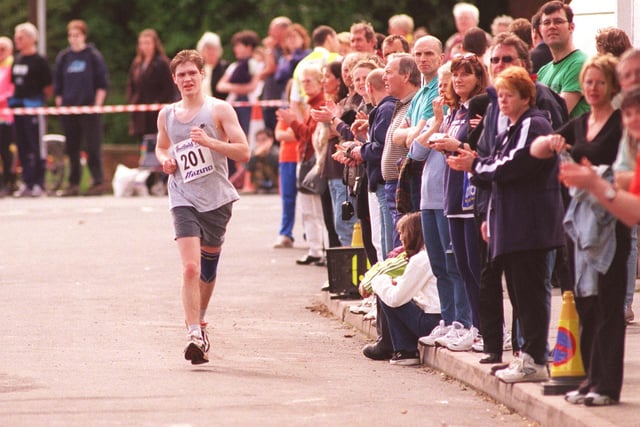 The strain starts to show at the half way point of the 1999 half marathon outside the stadium where this runner was pictured starting his second lap.