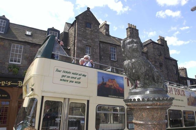 No tourist trip to Edinburgh is complete without visiting Bobby. An open-top bus is pictured making a stop at the statue in 2000.