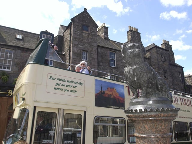 No tourist trip to Edinburgh is complete without visiting Bobby. An open-top bus is pictured making a stop at the statue in 2000.