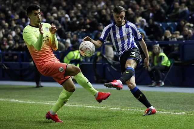 Morgan Fox of Sheffield Wednesday crosses the ball with Joao Cancelo of Manchester City attempting to block during the FA Cup Fifth Round match at Hillsborough. (Photo by Clive Brunskill/Getty Images)