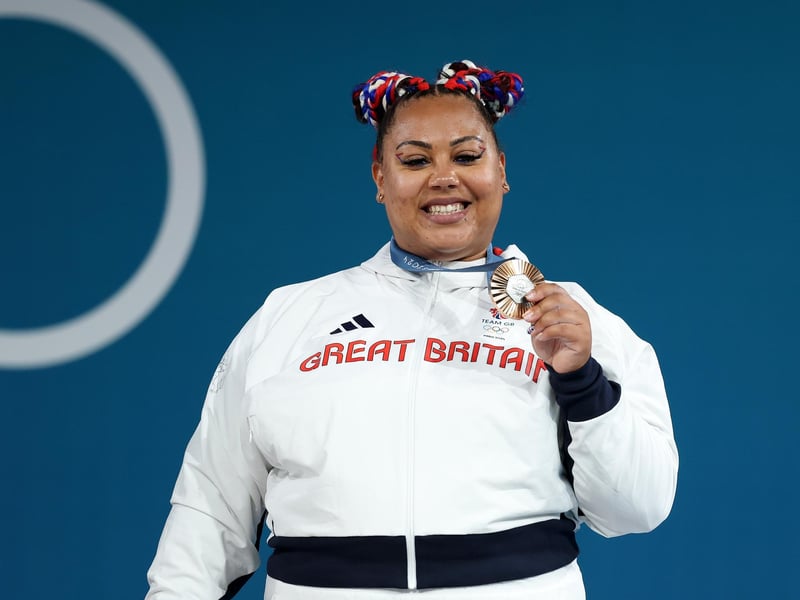 Emily Campbell beams with pride after taking the bronze medal for women's weightlifting.