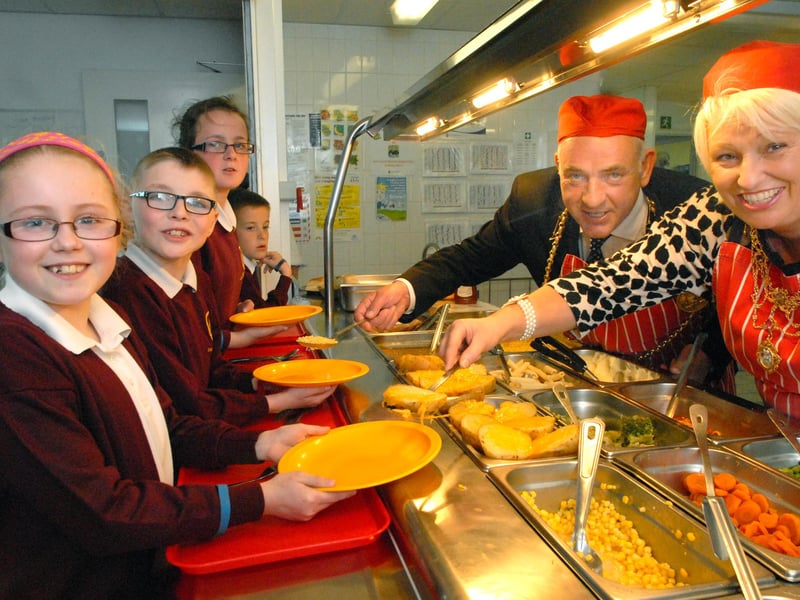 The Mayor and Mayoress take time out to serve the children at Holy Trinity School in this 2014 dinnertime session.