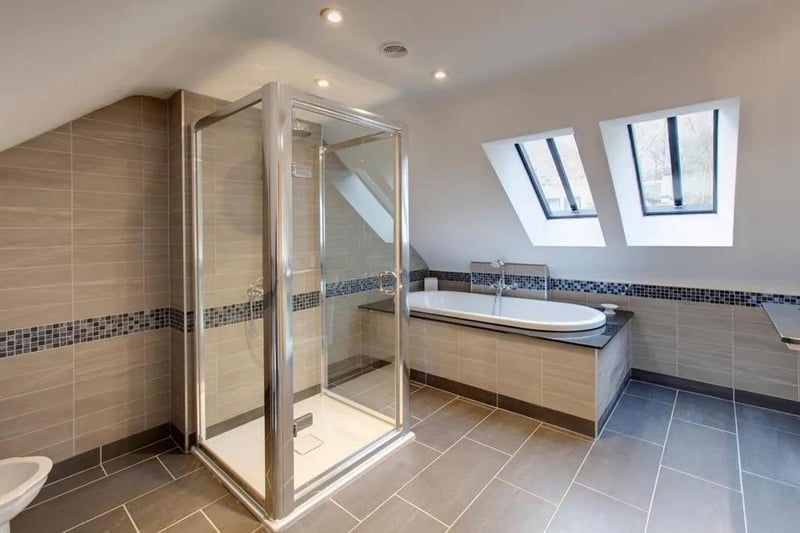 Suite in white, which comprises a low-level WC, bidet, two wash hand basins, panelled bath with chrome mixer tap and hand shower facility. Also having a shower enclosure with rain head shower, separate hand shower facility and glazed screen.