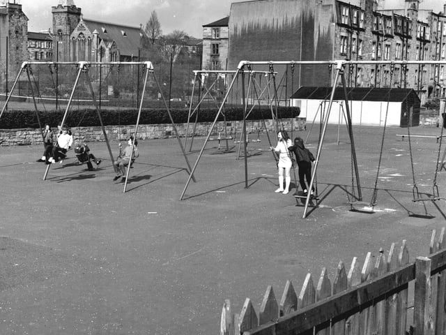Children playing on the swings in a playground in the Canonmills area of Edinbburgh in April 1971.