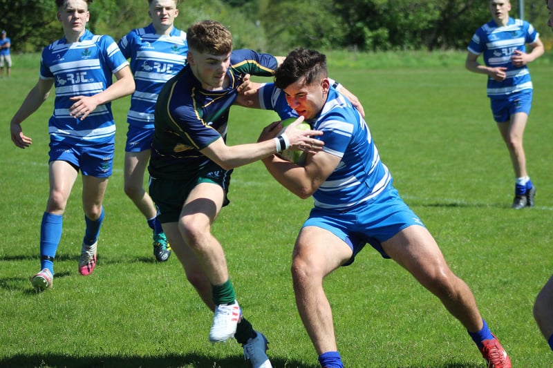 Jed Thistle's Gareth Williams fends off a Hawick challenge at Saturday's Melrose 10s tournament