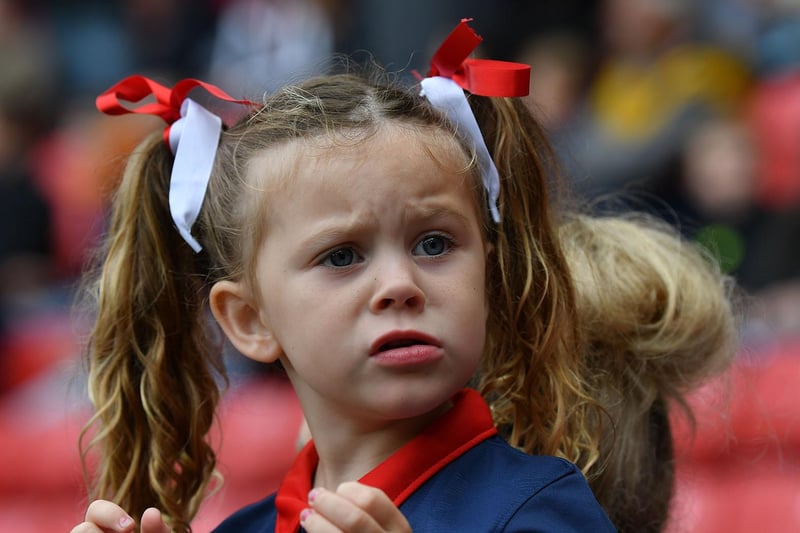 Something catches the eye of this young fan... and she doesn't look too impressed.