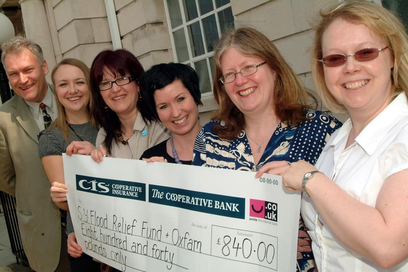 Cheque presentation to Oxfam and South Yorkshire Flood Appeal.  Money raised at a Fairtrade Fashion Show set up by Rotherham Borough Council workers.
Pictured in 2008 were: L-R Coun Ken Wyatt, Joanna Walker (Fair Trade Group, Rotherham Borough Council), Catherine Hatch (Oxfam, Manager Sheffield), Kate Taylor (Fair Trade Group, Rotherham Borough Council), Karen Alsop (South Yorkshire Community Foundation, Flood Fund) and Rachel Mellalieu (South Yorkshire Community Foundation, Flood Fund).