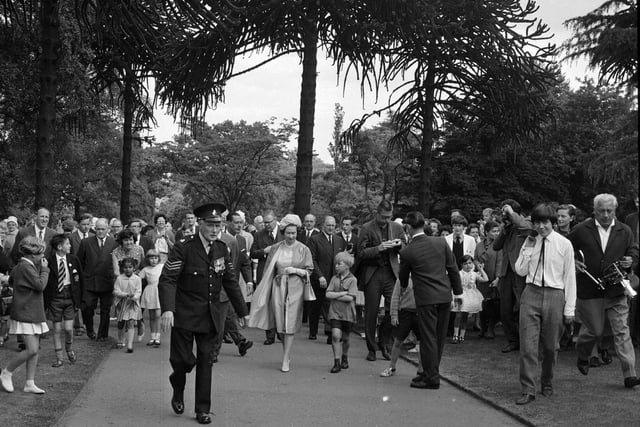 The Queen walks through the gardens during her visit in June 1964.