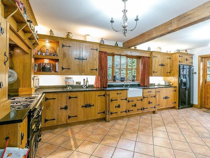 Marvel at this bespoke breakfast-kitchen. It features hand-made cabinets and units, a ceramic sink, a granite worktop and walk-in larder.