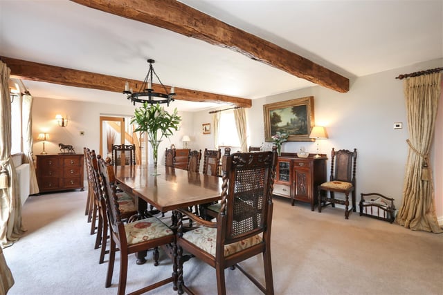 There is a grand formal dining room with feature fireplace.
