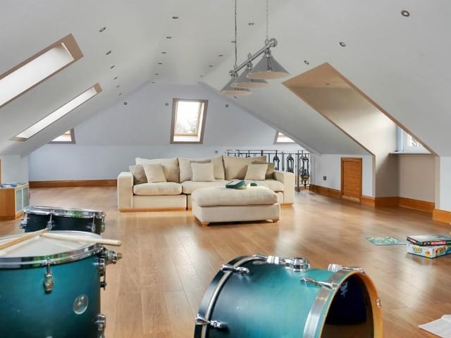 The second floor offers a substantial amount of living space, measuring 1,400 square feet, and could easily be split into two rooms. This room, with Velux roof windows at the front and back, could be a sixth bedroom, a teenager's retreat or a games room.