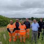 The image shows members of the Council’s Landscape Delivery and Green Spaces teams with Councillor David Sheppard at the Queen Elizabeth II Community Woodland.