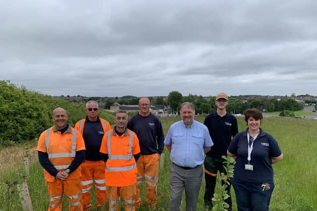 The image shows members of the Council’s Landscape Delivery and Green Spaces teams with Councillor David Sheppard at the Queen Elizabeth II Community Woodland.