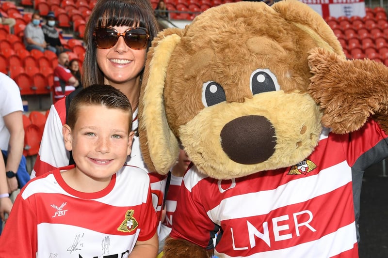 A young supporter meets Rovers mascot Donny Dog