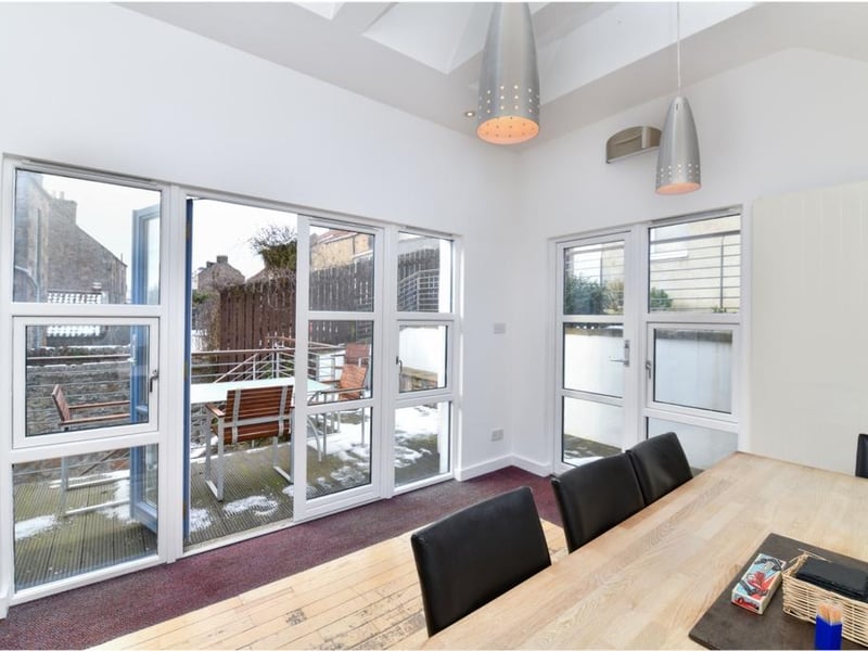 Dining room with access to outdoor seating area.