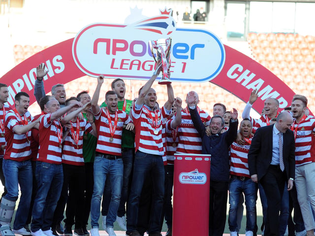 Captain Rob Jones lifts the League One trophy for Rovers