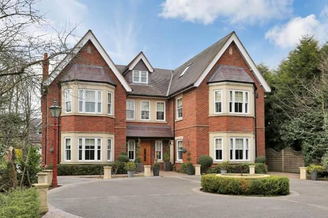 The imposing frontage of the property, named Hi-Fi, which sits on Linby Lane in Linby. A walled driveway extends over the picturesque village stream, leading to electric gates that open on to the immaculate front garden.