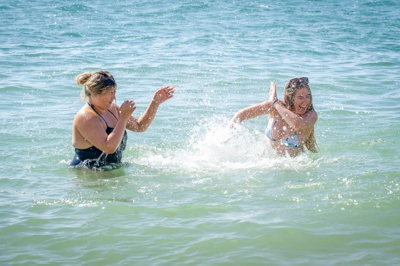 Friends Grace Osbourne and Lucy Wright having a splash fight in the sea. Picture: Habibur Rahman