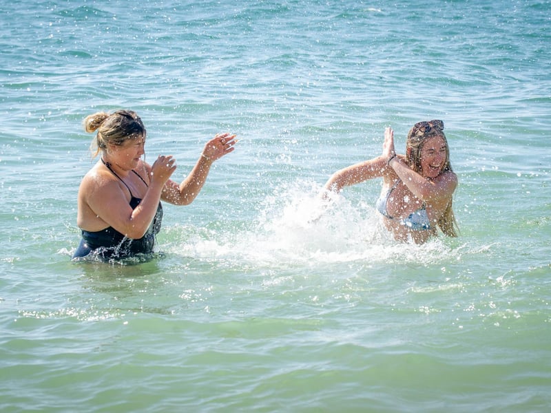 Friends Grace Osbourne and Lucy Wright having a splash fight in the sea. Picture: Habibur Rahman
