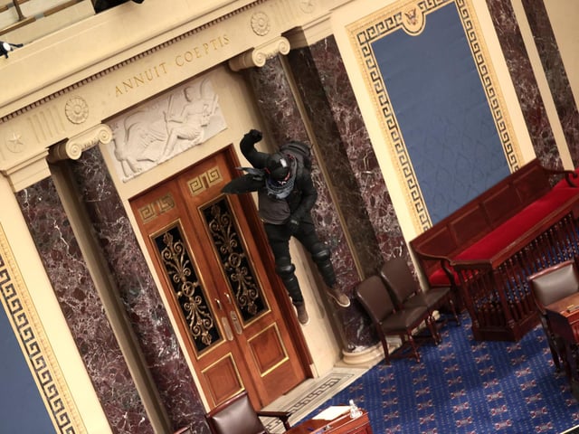 Protesters enter the Senate Chamber on January 06, 2021 in Washington, DC. Congress held a joint session today to ratify President-elect Joe Biden's 306-232 Electoral College win over President Donald Trump. Pro-Trump protesters have entered the U.S. Capitol building after mass demonstrations in the nation's capital. (Photo by Win McNamee/Getty Images)