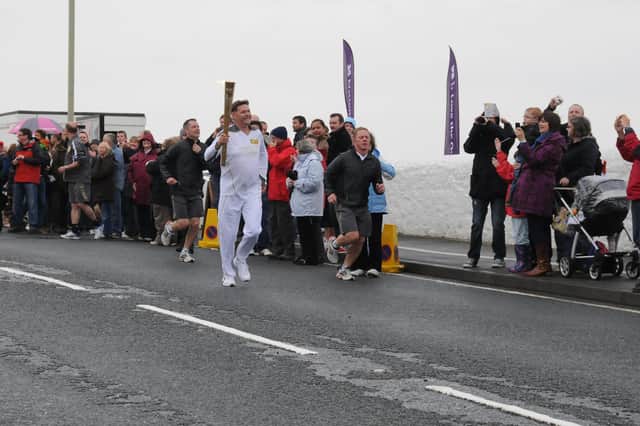 Jerard Hoburn runs with the torch from Souter Lighthouse to Whitburn. Does this bring back memories from 2012?