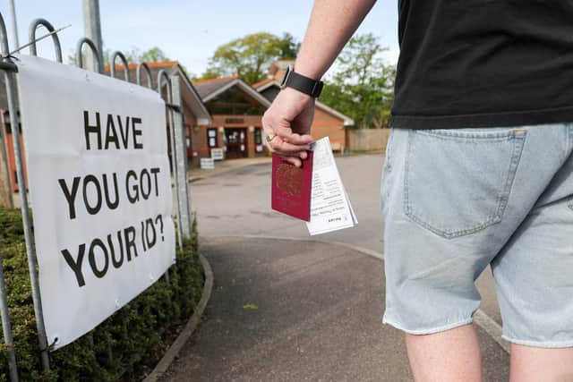 A voter carries his passport along with his poll card, as he makes his way to vote at The Vyne polling station in Knaphill, part of the Woking borough, which one of five Councils working with Cabinet Office to trial the use of ID in polling stations.  PRESS ASSOCIATION Photo. Picture date: Thursday May 3, 2018. See PA story POLITICS Election. Photo credit should read: Andrew Matthews/PA Wire