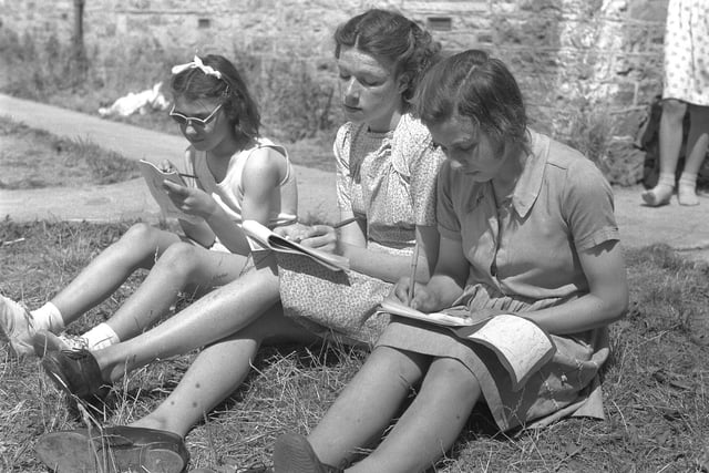 Norma Stephenson, Eva Elders and Margaret Gillis find time to write home.
