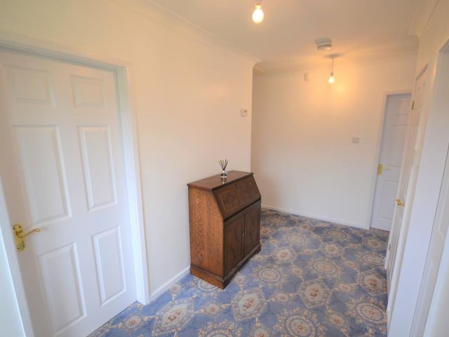 Reception Hall - A spacious area for greeting guests with matching gloss white six panel doors opening to the breakfast kitchen, sitting room, all three bedrooms and the family shower room, there is a power socket, central heating radiator, alarm control panel, loft access and coving to the ceiling.
