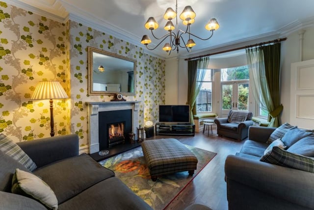 The delightful sitting room has a curved bay window incorporating patio doors into the garden and an ornate marble fireplace housing a living flame gas fire.