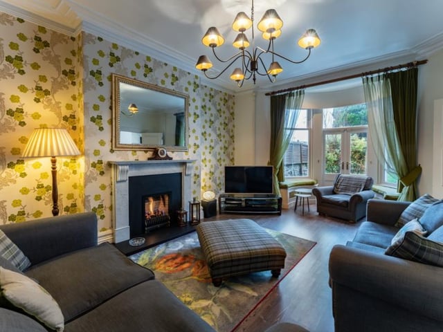 The delightful sitting room has a curved bay window incorporating patio doors into the garden and an ornate marble fireplace housing a living flame gas fire.