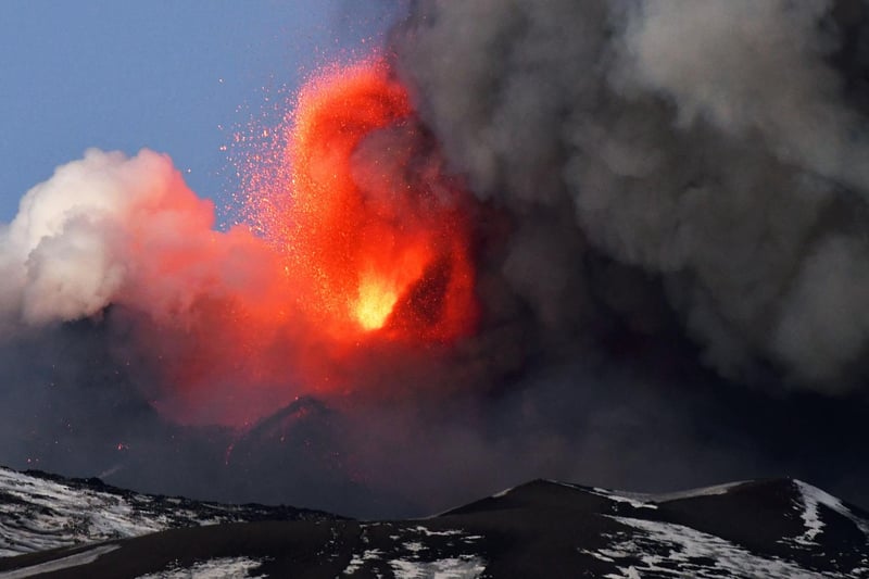 This photo obtained from Italian news agency ANSA shows the Etna volcano in Catania, Sicily, on February 16, 2021 during a spectacular eruption and a strong explosive activity from the south-east crater and the emission of a high cloud of lava ash that disperses towards the south.