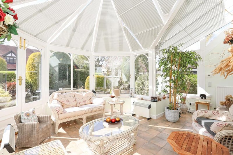 The property boasts a stunning garden room on the west side of the house, described as a "bright conservatory looking out onto the gardens".