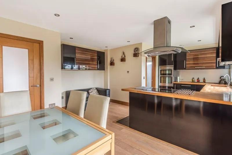 The kitchen provides a clear view into the living room.