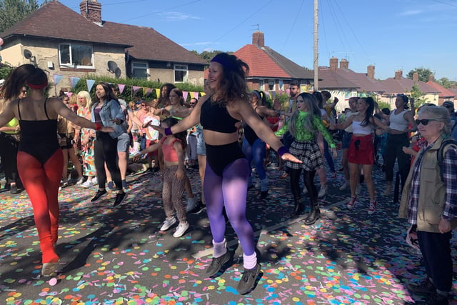 Members of the crowd with dancers during the Everybody's Talking About Jamie street party on Deerlands Avenue, Parson Cross, Sheffield, where the cinema version was filmed