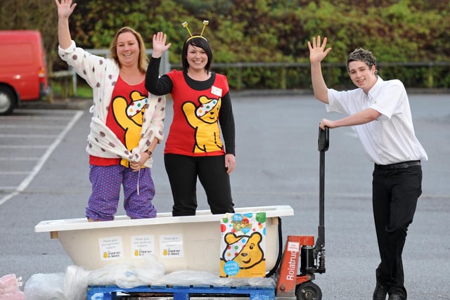 2010. In a bath of custard at Morrisons store at Dell Piece West at Horndean all in the good cause of Children In Need!
(left to right) Sara Potten (39), with Kerry Taylor (22) as Aaron Dudman (19) steadies the trolley 
Picture: Malcolm Wells (103773-2104)