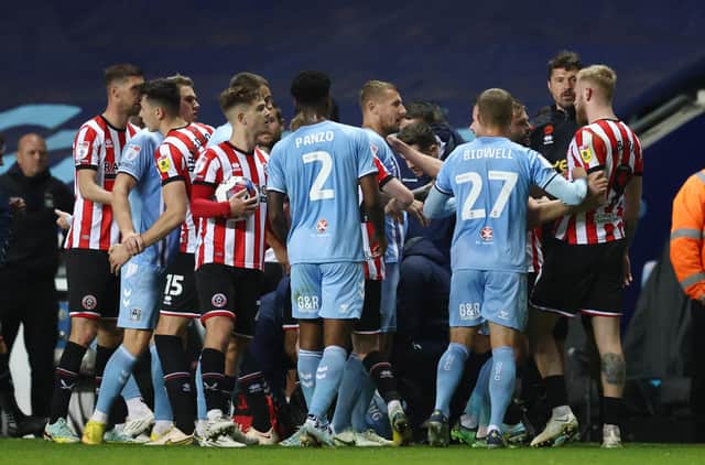 Players from Sheffield United and Coventry City come together following a bad tackle by Fankaty Dabo: Darren Staples / Sportimage