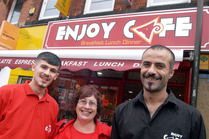 Enjoy Café owner Taylan Oztoprak, right, and manager Diyar Tasdelen are pictured with regular customer Jenny Dunning outside their Sutton diner.