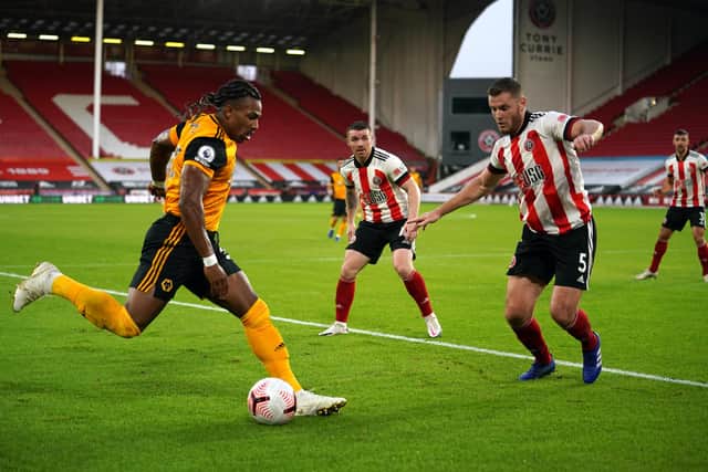 Adama Traore of Wolverhampton Wanderers is put under pressure by Jack O'Connell of Sheffield United.