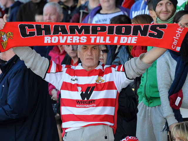 A Rovers fan celebrates at the presentation of the League One trophy