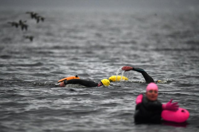 TROSSACHS, SCOTLAND - OCTOBER 20: Open water swimming enthusiasts enjoy an early morning swim in Loch Lomond,Trossachs, Scotland. A new study from the UK Dementia Research Institute found that the blood of regular winter swimmers contains a "cold-shock" protein that wasn't found in that of people who did other cold-weather exercise on dry land.