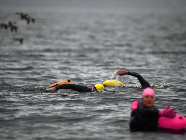 TROSSACHS, SCOTLAND - OCTOBER 20: Open water swimming enthusiasts enjoy an early morning swim in Loch Lomond,Trossachs, Scotland. A new study from the UK Dementia Research Institute found that the blood of regular winter swimmers contains a "cold-shock" protein that wasn't found in that of people who did other cold-weather exercise on dry land.
