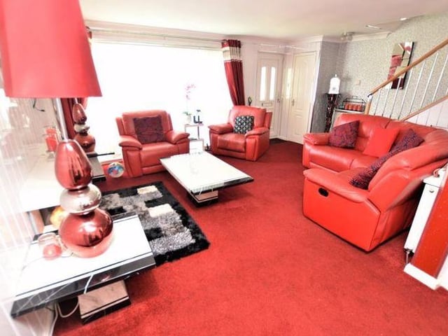 The living room benefits from an open plan lounge and dining area design, with front facing windows letting in loads of natural light