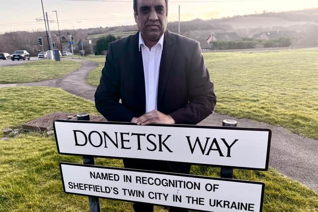 Councillor Shaffaq Mohammed, leader of Sheffield Liberal Democrats, standing with the sign for Donetsk Way - named after the Ukrainian city which is twinned with Sheffield.