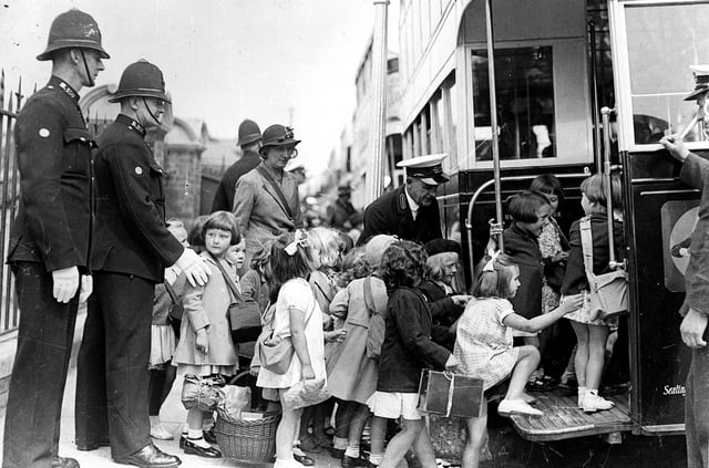 Portsmouth children being evacuated in 1939. The girl on the left is Marjorie Charman nee Watts. Evacuees board buses at George Street, Portsmouth at the beginning of the Second World War. The News PP5415