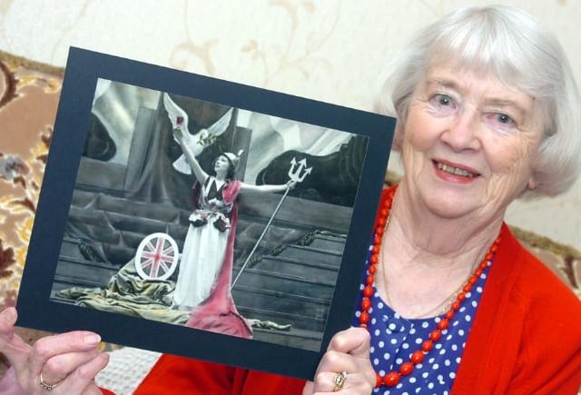 Joan Watson from Balby photographed with a photo of herself from her youth as a performer, 2005.