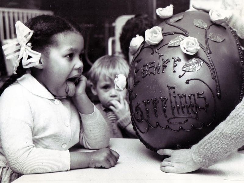 Licking her lips in anticipation of the forthcoming feast is 4-years-old Patricia Wells, one of the patients of the Sheffield Children's Hospital, who helped to dispose of this giant Easter egg presented to the hospital by Sheffield department store, Walsh's... March 1967