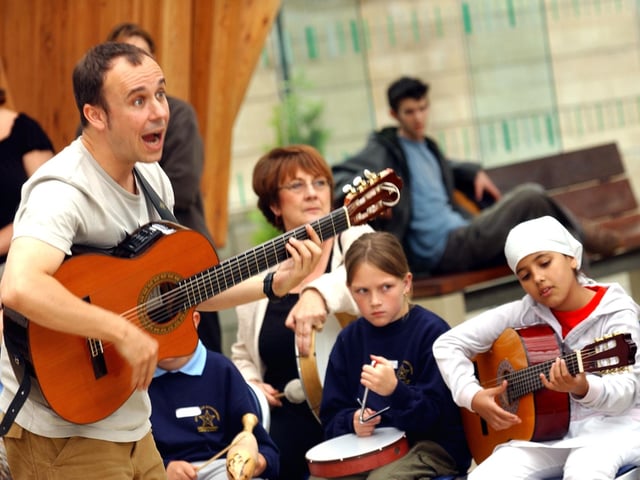 Sheffield school children from various schools performed with two professional musicians in the Sheffield Winter Garden in 2003. Pictured is Rikki Thomas Martinez performing with some of the students