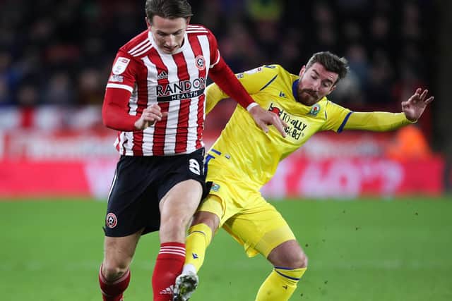 Sander Berge of Sheffield United (left) and Joe Rothwell of Blackburn Rovers battle for the ball: Isaac Parkin / Sportimage